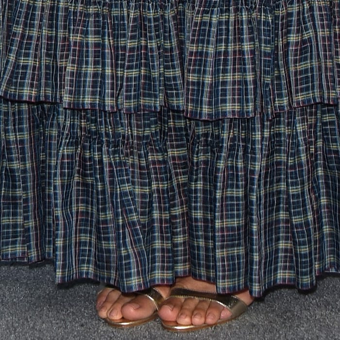 Her Alexandre Birman Willow sandals peek out from beneath the tiered Chanel gown, adding a metallic finish to the look