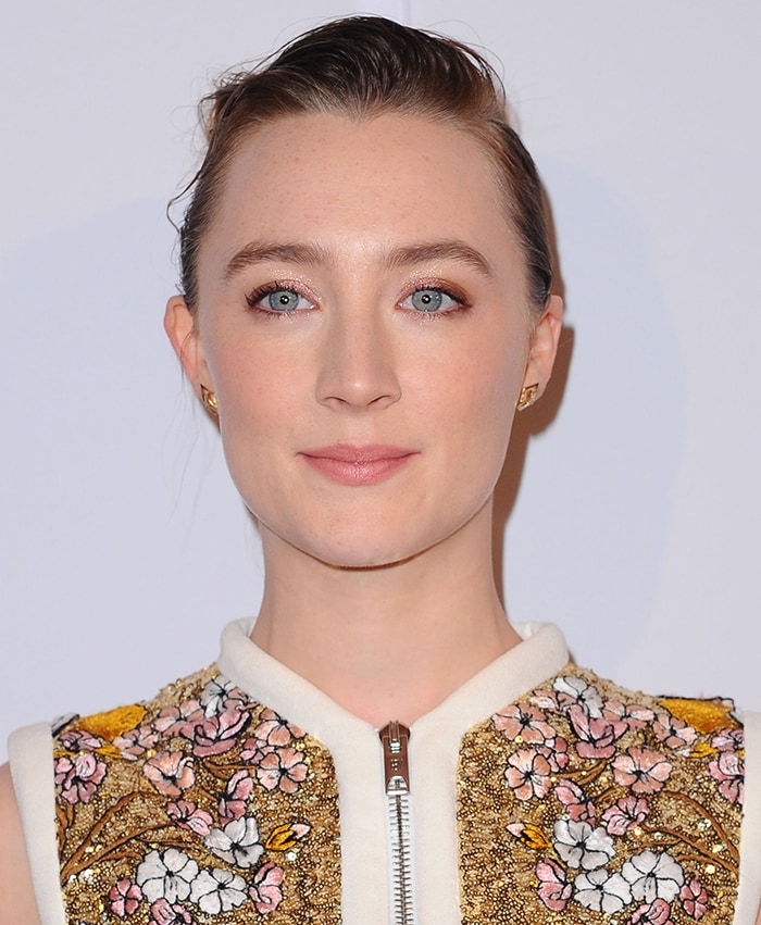 Close-up of Saoirse Ronan's slicked-back updo and floral Giambattista Valli embroidery at the BAFTA Tea Party
