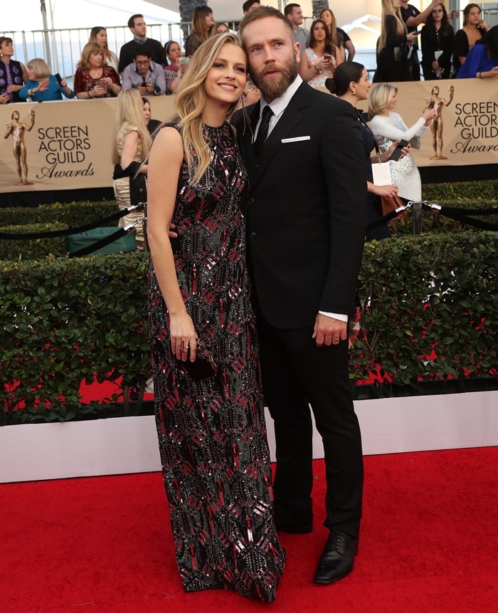 Teresa Palmer dazzles in a floor-length sequined gown with intricate beadwork, accompanied by her husband, Mark Webber, in a classic black suit at the 23rd Annual Screen Actors Guild Awards at The Shrine Expo Hall in Los Angeles on January 29, 2017