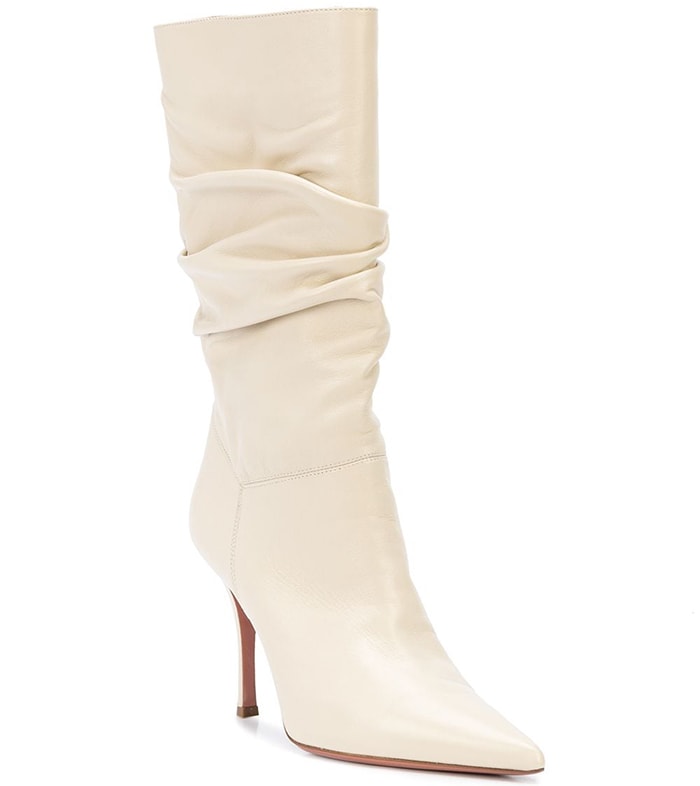 Light cream leather Ida slouchy boots from Amina Muaddi featuring a pointed toe, gathering details, a slip-on style, a mid-calf length and a high stiletto heel