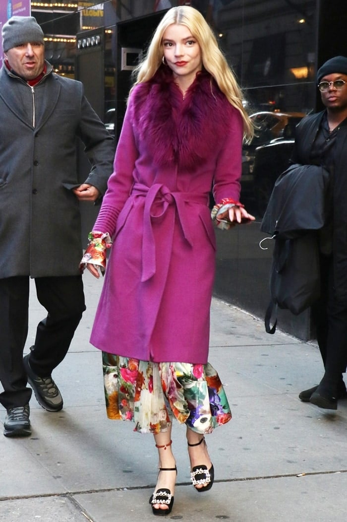 Anya Taylor-Joy arrives at the Good Morning America studios in a floral Prabal Gurung dress layered under a magenta Sentaler coat, finished with sparkling Roger Vivier platform sandals