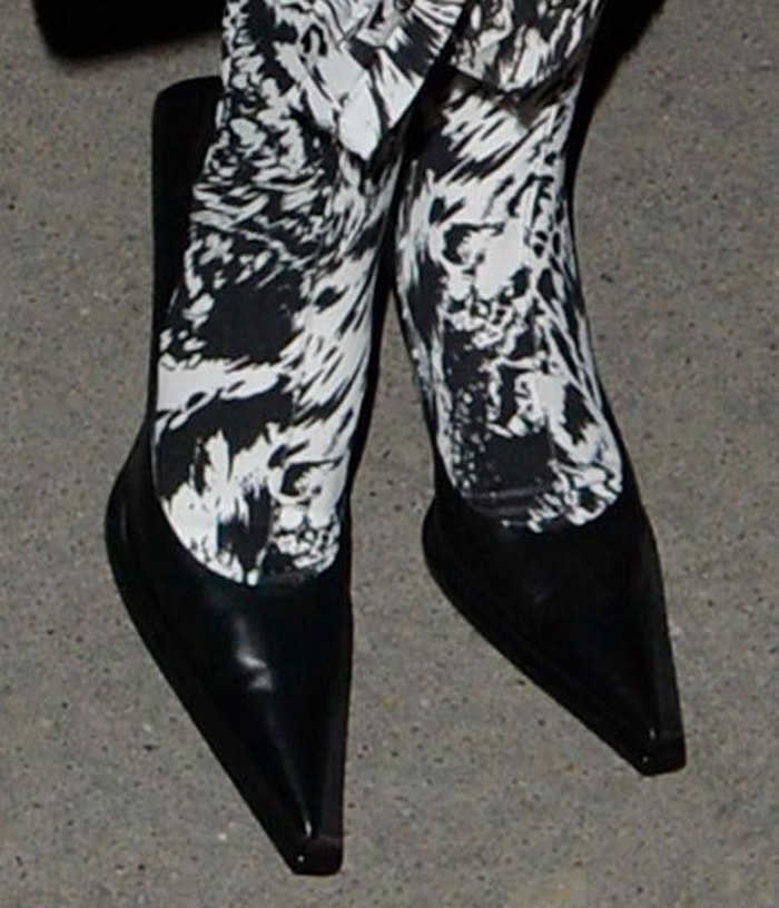 Bella Hadid's Balenciaga Square Knife pumps featured elongated pointed toes and sharply angled heels, extending the dramatic lines of her monochrome ensemble