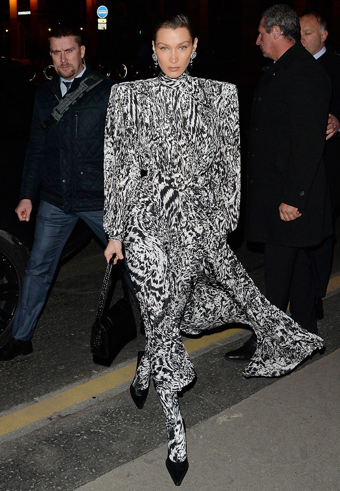 Bella Hadid embraced Balenciaga's bold tailoring in a black-and-white animal-print dress, matching printed leggings, and signature Square Knife pumps for the Harper's Bazaar Exhibition during Paris Fashion Week