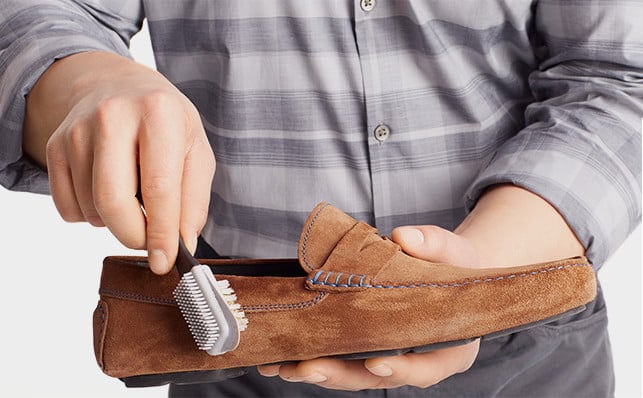 Brushing a suede shoe to restore its nap, as demonstrated by Nordstrom
