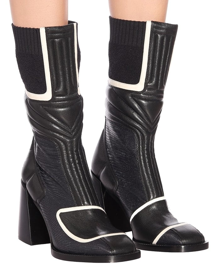 Chloé Bell ankle boots combine square toes, stretch-knit cuffs, and sculptural block heels with paneled leather construction, creating a distinctive hybrid of sock boot and ankle boot that reflects the house's modern, sporty approach to luxury footwear