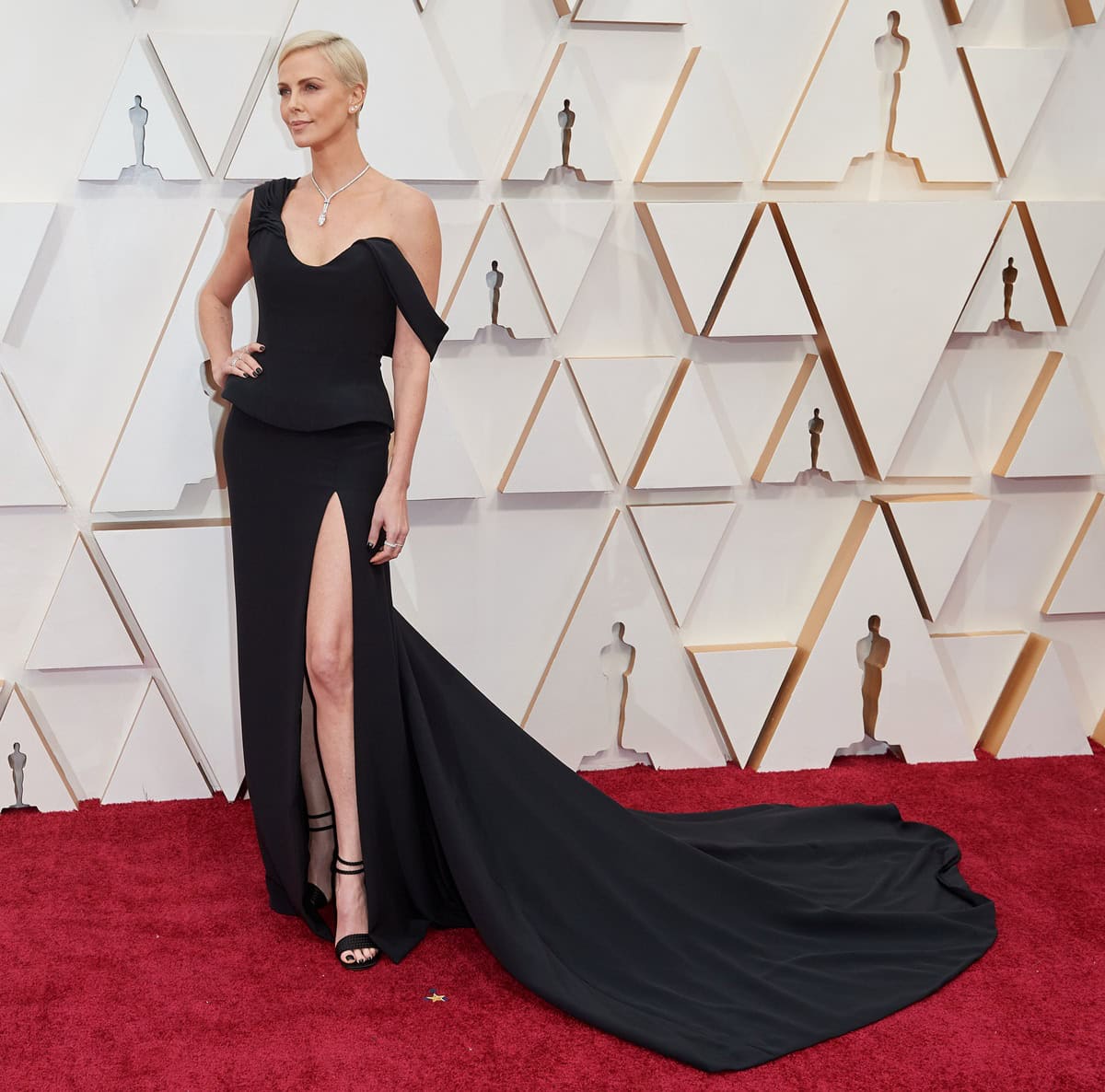 Charlize Theron commands the 92nd Academy Awards red carpet in a sculptural black Christian Dior Haute Couture gown accented with dazzling Tiffany Co. jewelry