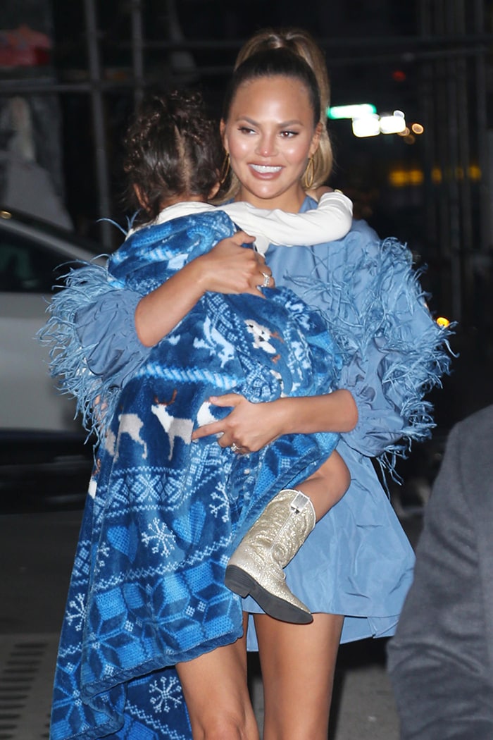 Chrissy Teigen pairing soft neutral makeup and a sleek high ponytail