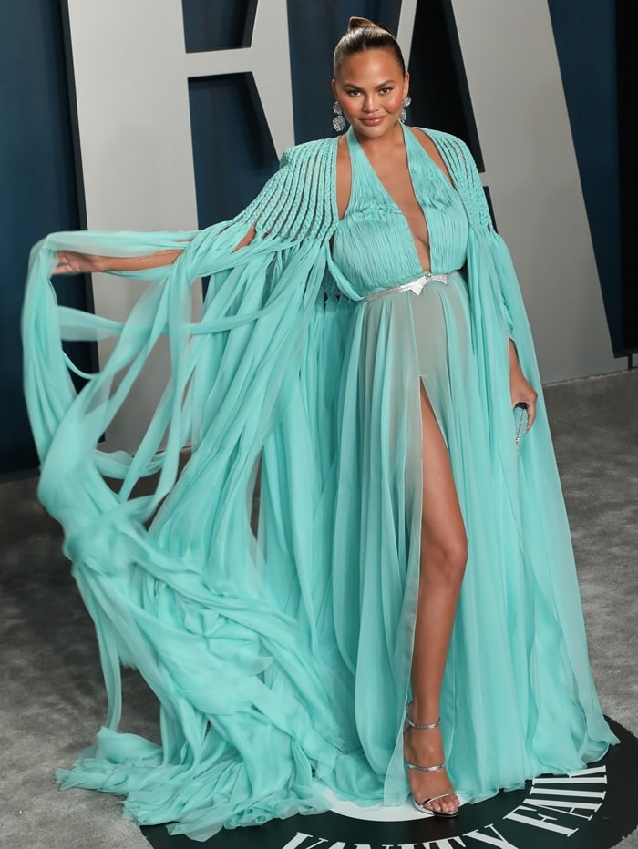 Chrissy Teigen wore a Georges Hobeika dress, Giuseppe Zanotti heels, Heliopolis clutch, and Lorraine Schwartz jewelry