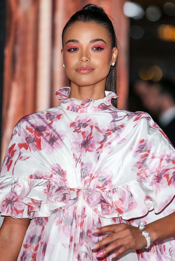 Ella Balinska pairs her floral Giambattista Valli gown with a sleek high ponytail and monochromatic pink eye makeup for a fresh, romantic BAFTA beauty moment