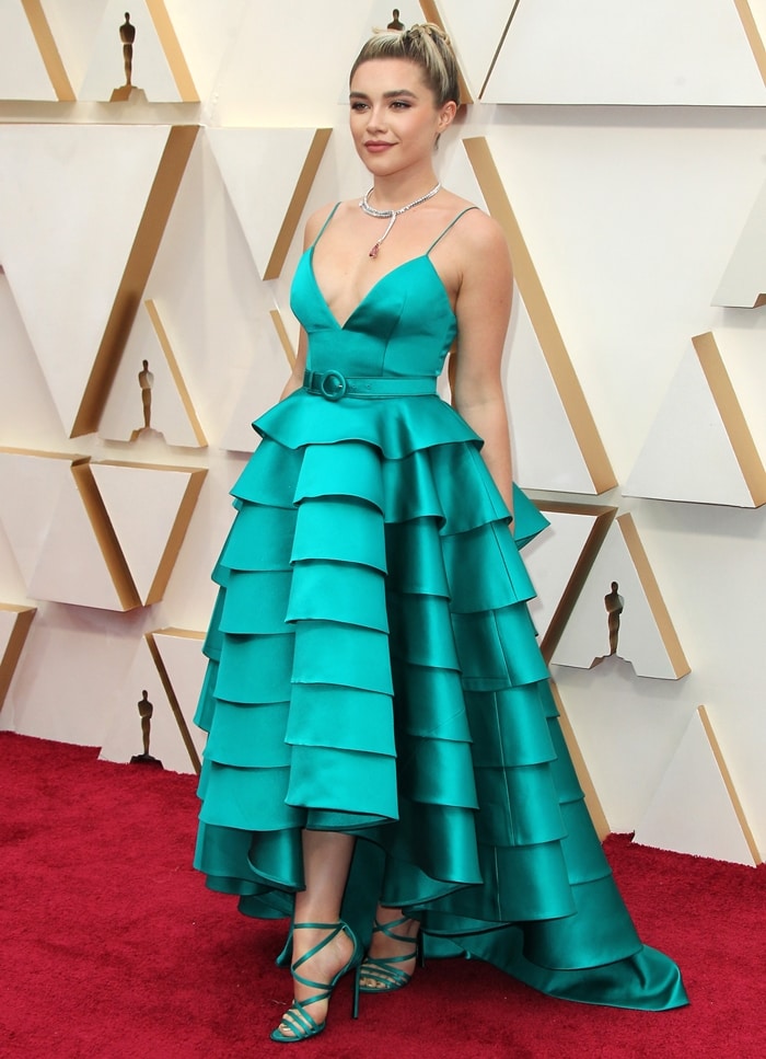 Florence Pugh's custom Louis Vuitton ensemble achieved a seamless monochromatic effect, with teal satin stiletto sandals dyed to match the tiered silk gown exactly