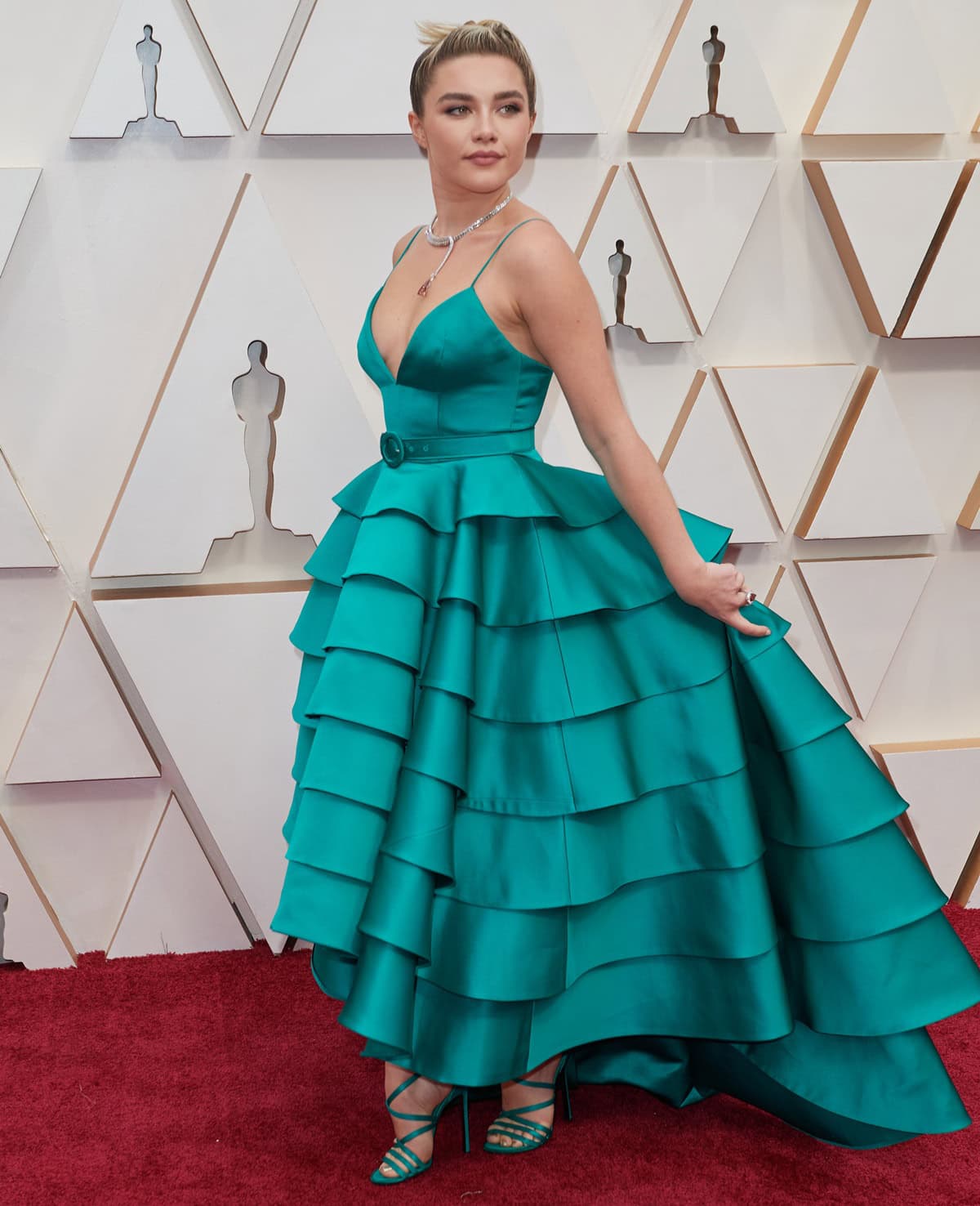 The dramatic cascading ruffles of Florence Pugh's custom Louis Vuitton gown frame the barely-there strappy sandals that peek out beneath the asymmetrical hemline