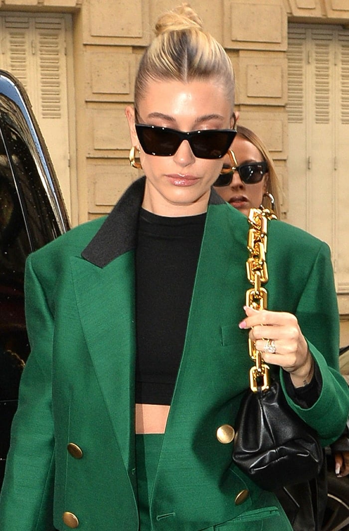 Hailey Bieber keeps it simple and neat with neutral makeup and center-parted bun