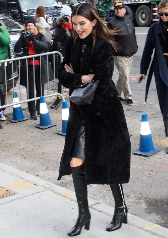 Earlier that month at New York Fashion Week, Kendall Jenner balanced a voluminous Balenciaga dyed lamb-shearling coat with another pair of structured knee-high boots, reinforcing the footwear silhouette that became a hallmark of her February 2020 wardrobe
