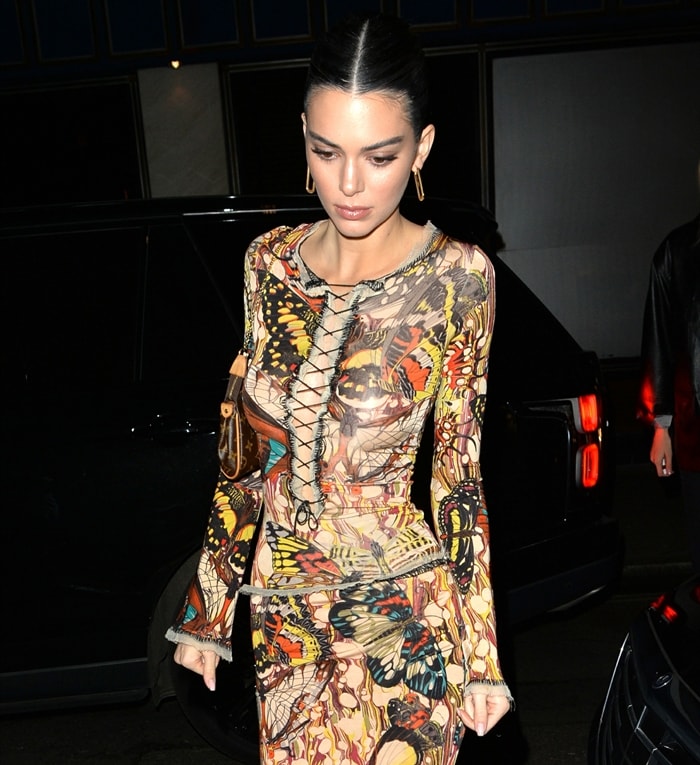 A closer look at Kendall Jenner's early-2000s Jean Paul Gaultier butterfly-print top highlights the lace-up front and semi-sheer construction that defined one of the designer's most recognizable archival motifs