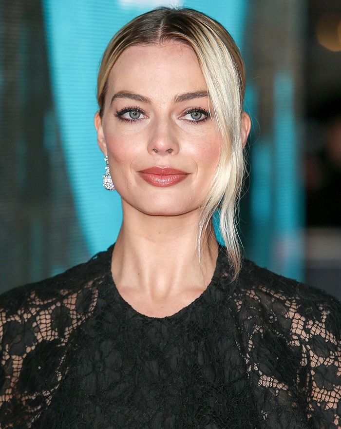 Margot Robbie pairs kohl-rimmed eyes with a swept-back peroxide-blonde updo for a sleek, modern beauty moment at the 2020 BAFTAs