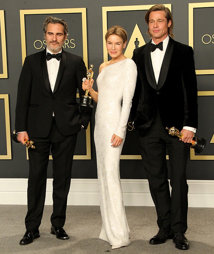 Academy Awards winners Joaquin Phoenix, Renée Zellweger, and Brad Pitt pose together with their Oscar trophies