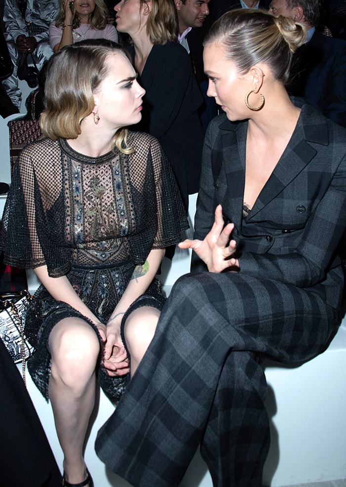 Cara Delevingne sits front row with Karlie Kloss at the Christian Dior Fall/Winter 2020 runway show