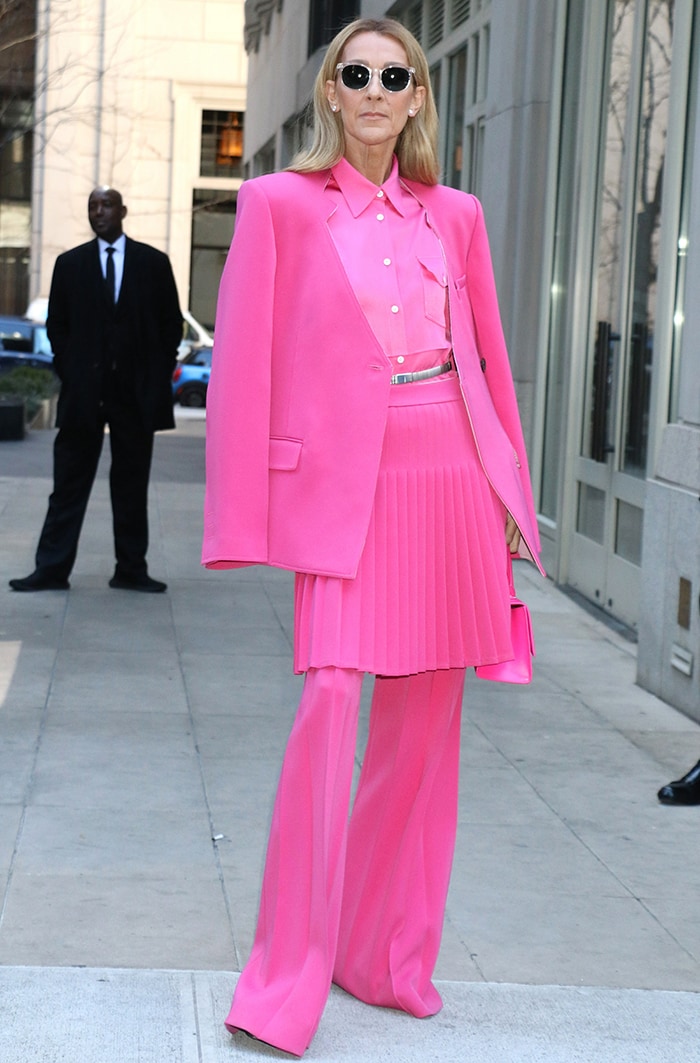 Celine Dion embraces monochromatic dressing in a Peter Do hot-pink ensemble styled with Gianvito Rossi Dasha platform boots and a Balenciaga Hourglass bag