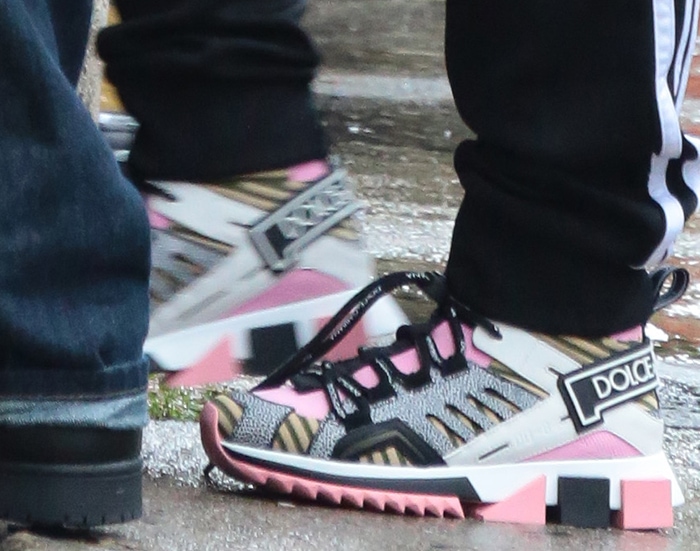 Christina Aguilera’s Dolce Gabbana sneakers combined pink mesh panels, graphic logo straps, and exaggerated serrated soles for a bold streetwear statement