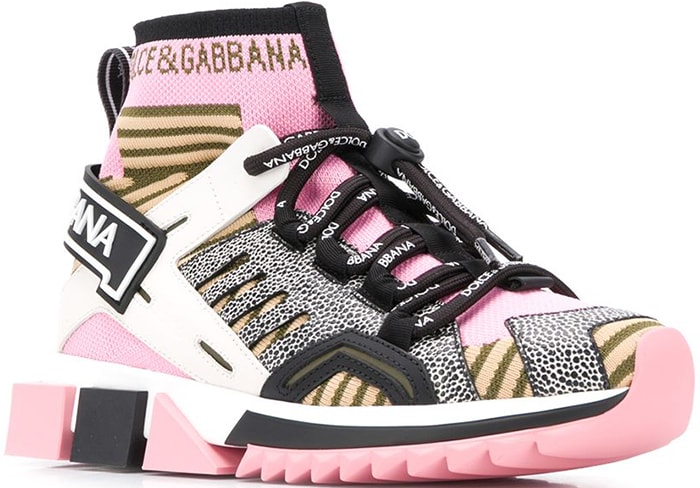 Dolce Gabbana’s “Sorrento” high-top sneakers feature a sock-style upper, mixed animal-inspired textures, and oversized geometric rubber soles