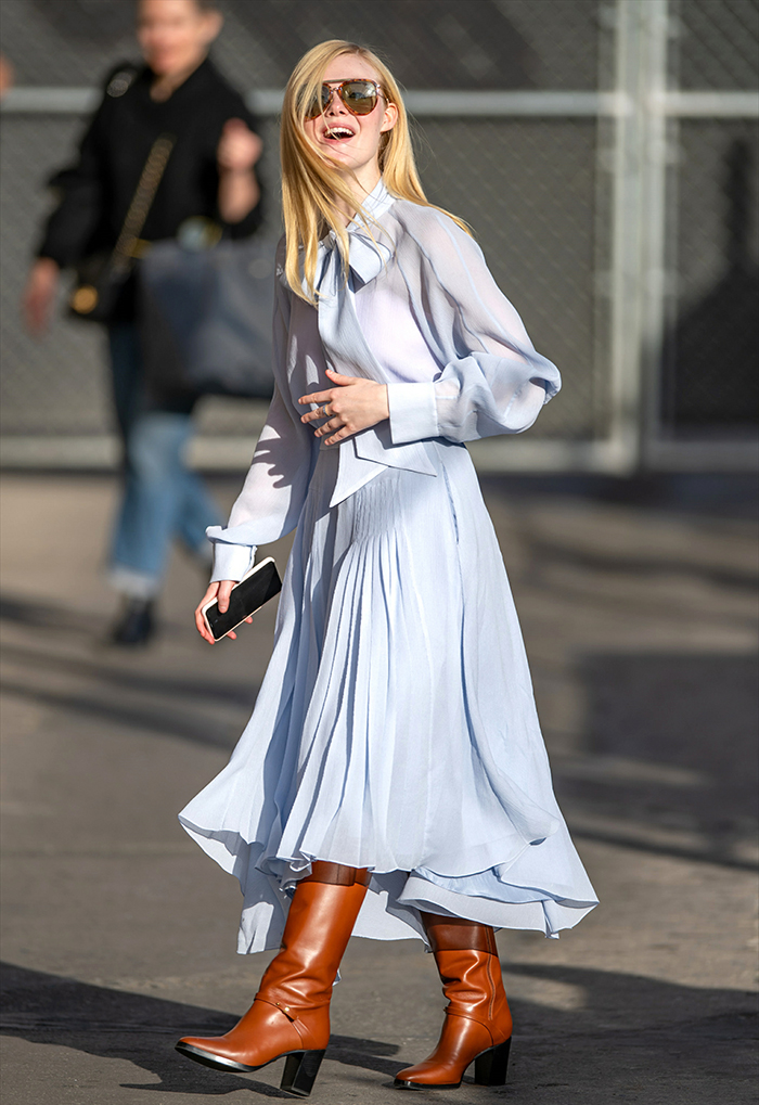 The actress showcases the movement of her '70s-inspired Rochas ensemble, highlighting how high-shaft leather boots can ground a feminine, airy silhouette