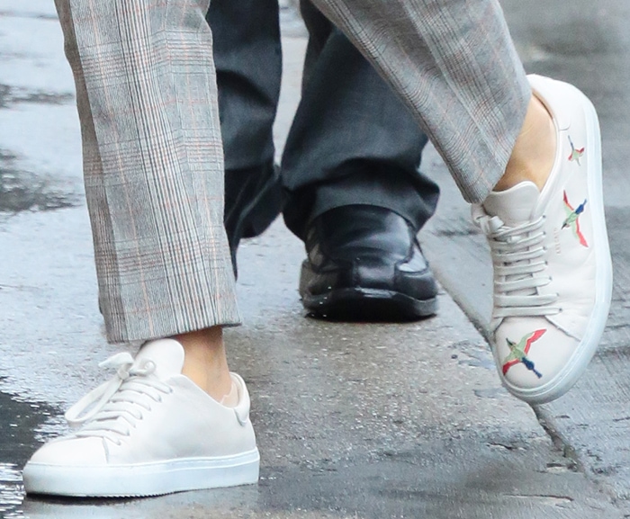 A closer look at Emily Blunt's Axel Arigato Clean Bird sneakers reveals the colorful embroidered bird motifs that distinguish the minimalist white leather design