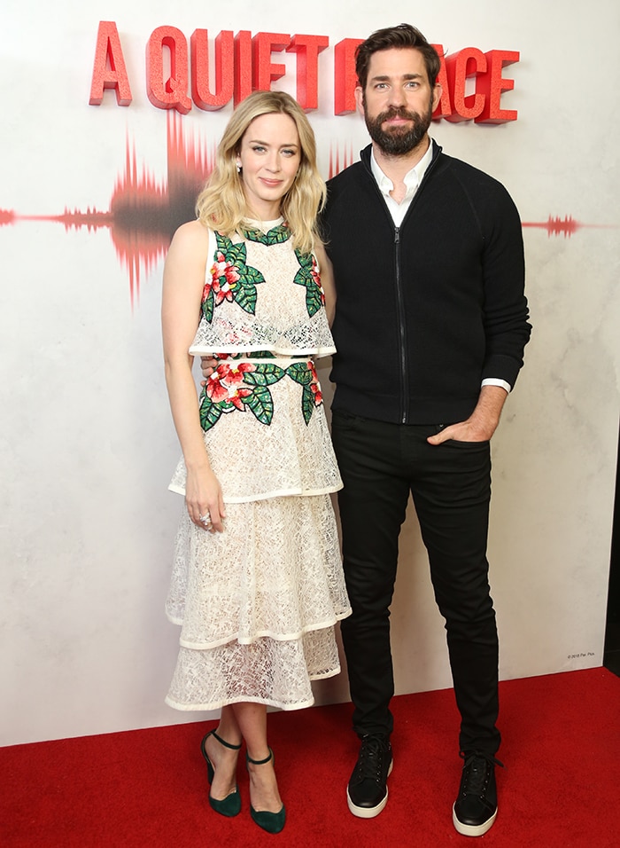 Emily Blunt attended the London premiere of A Quiet Place on April 5, 2018, in an embroidered Elie Saab dress featuring floral and foliage appliqués, pairing the romantic tiered design with green Christian Louboutin Aketi pumps that subtly echoed the dress's botanical color palette