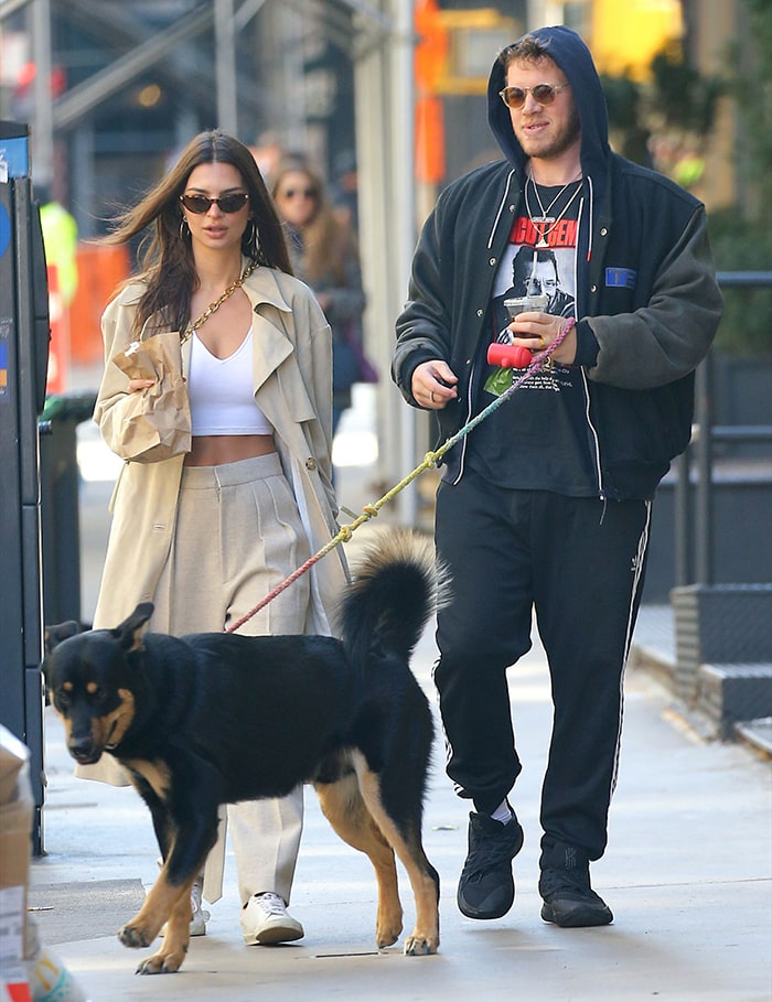 Walking Colombo alongside Sebastian Bear-McClard, Emily coordinates cream tailoring with white low-top sneakers for a polished take on practical dog-walking style