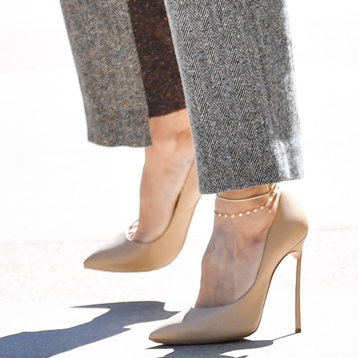 Heidi Klum’s nude Casadei pumps create a clean, leg-lengthening finish with razor-sharp pointed toes and towering stiletto heels