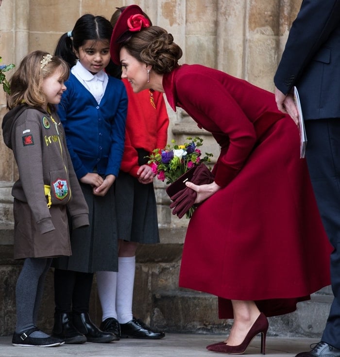 Kate's berry-red ensemble balanced regal formality with modern restraint, pairing a custom Catherine Walker coatdress with carefully coordinated accessories