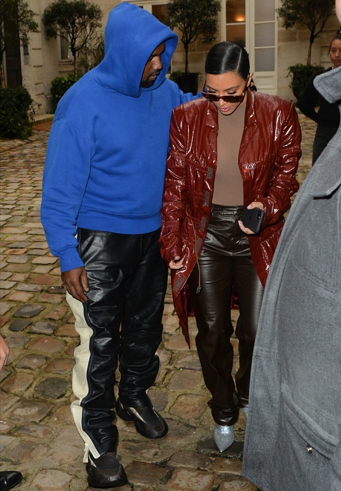 Kim Kardashian wears silver Balenciaga Knife booties with brown leather pants while walking with Kanye West in Paris