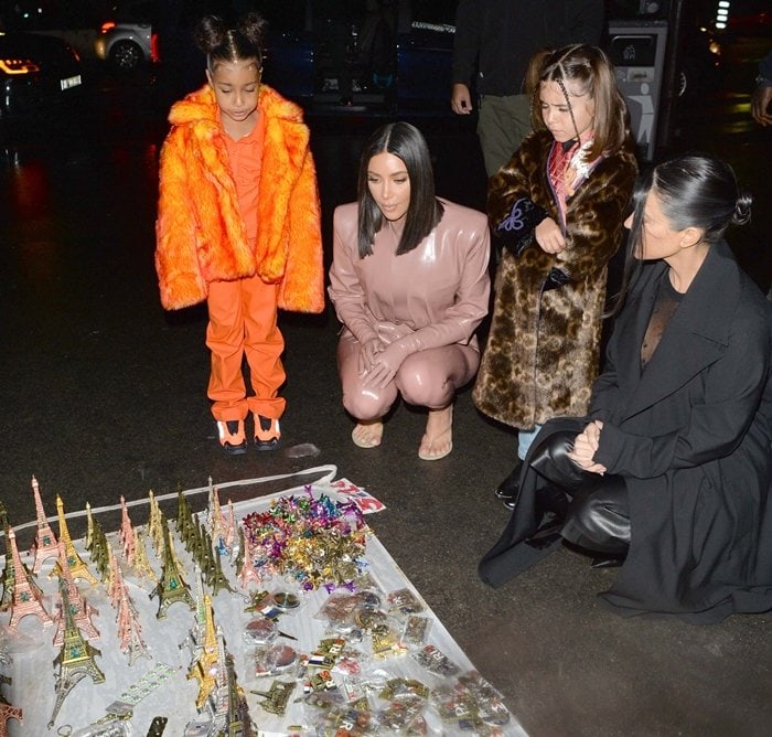 Kim Kardashian, North West, Penelope Disick, and Kourtney Kardashian are seen near the Eiffel Tower