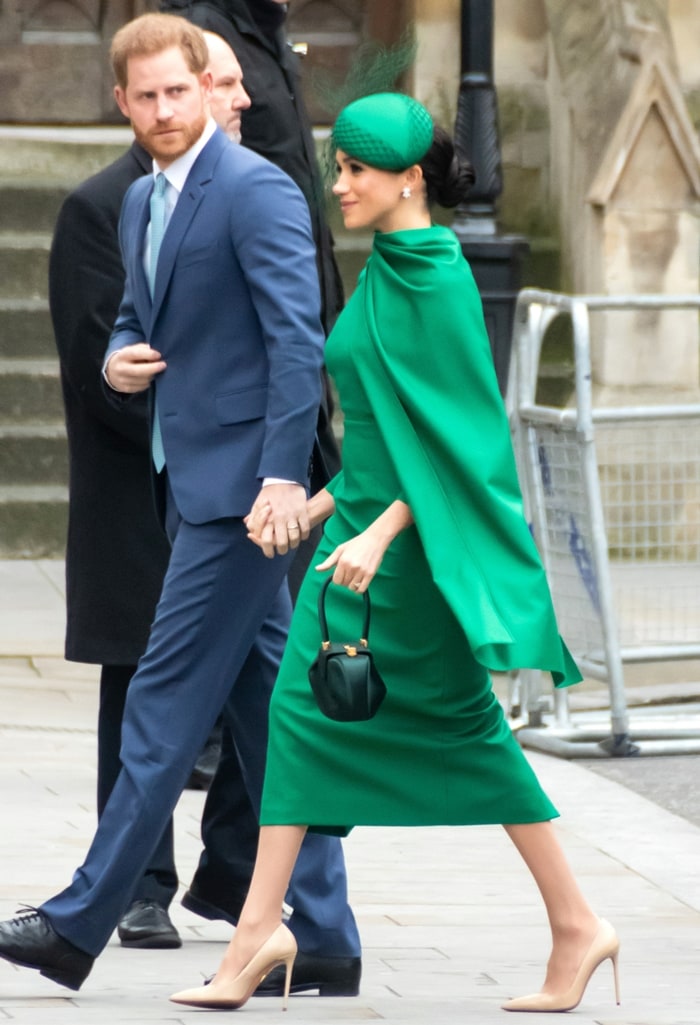 Meghan Markle paired her emerald green Emilia Wickstead cape dress with nude Aquazzura pumps, using the soft neutral heels to streamline the bold monochromatic look while adding extra length to her silhouette