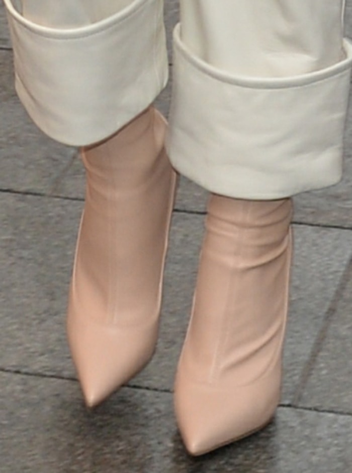 A close-up highlights Rita Ora’s Le Silla Eva boots, featuring a sleek sock-like fit and sharply pointed toe