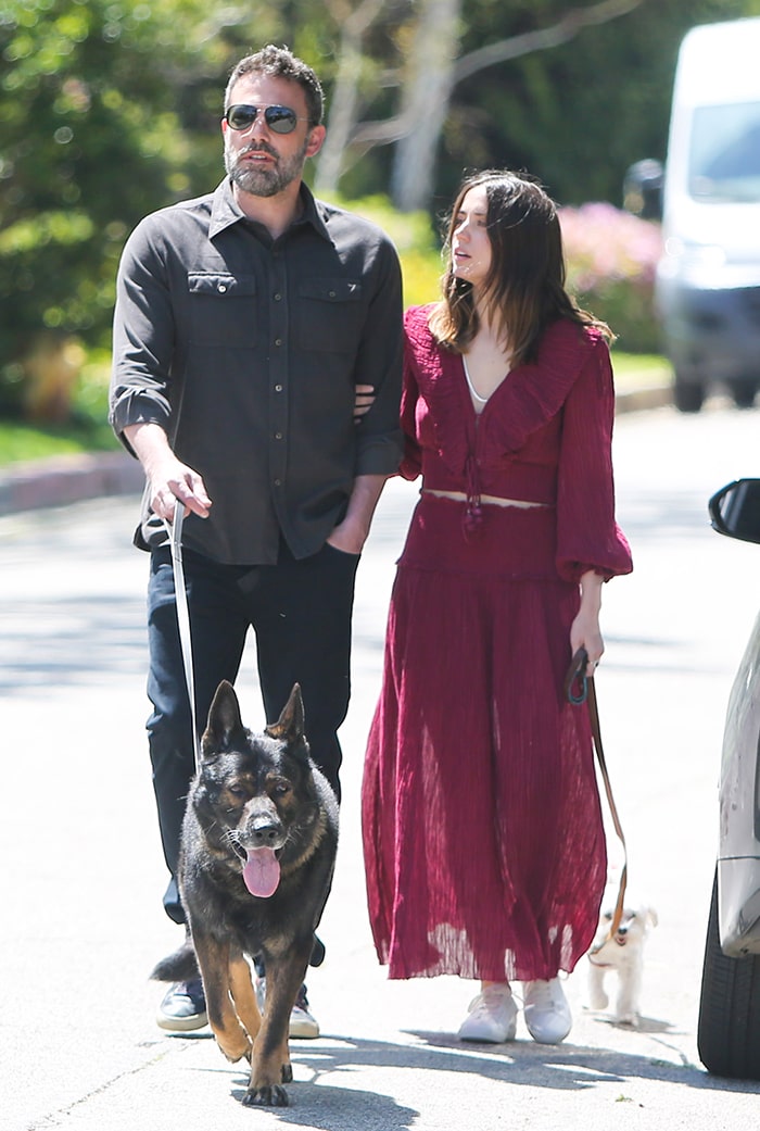 Ana de Armas styled a flowing ruby-red Zimmermann set with crisp white Saint Laurent “Andy” sneakers while walking arm-in-arm with Ben Affleck in Pacific Palisades on March 30, 2020