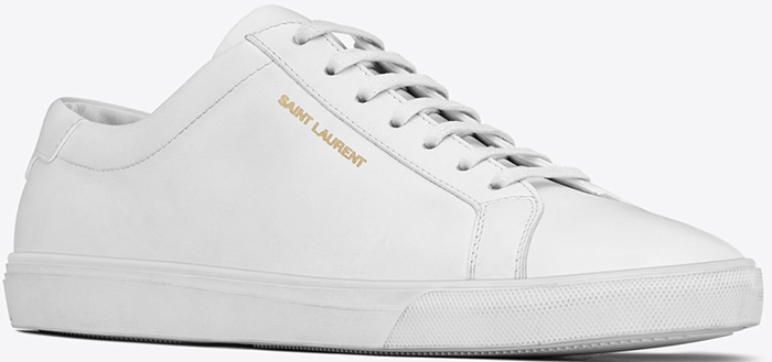 Saint Laurent’s “Andy” sneakers in smooth Optic White leather feature the label’s signature minimalist silhouette and subtle gold-foil branding, retailing for about $525 when Ana de Armas wore them in 2020