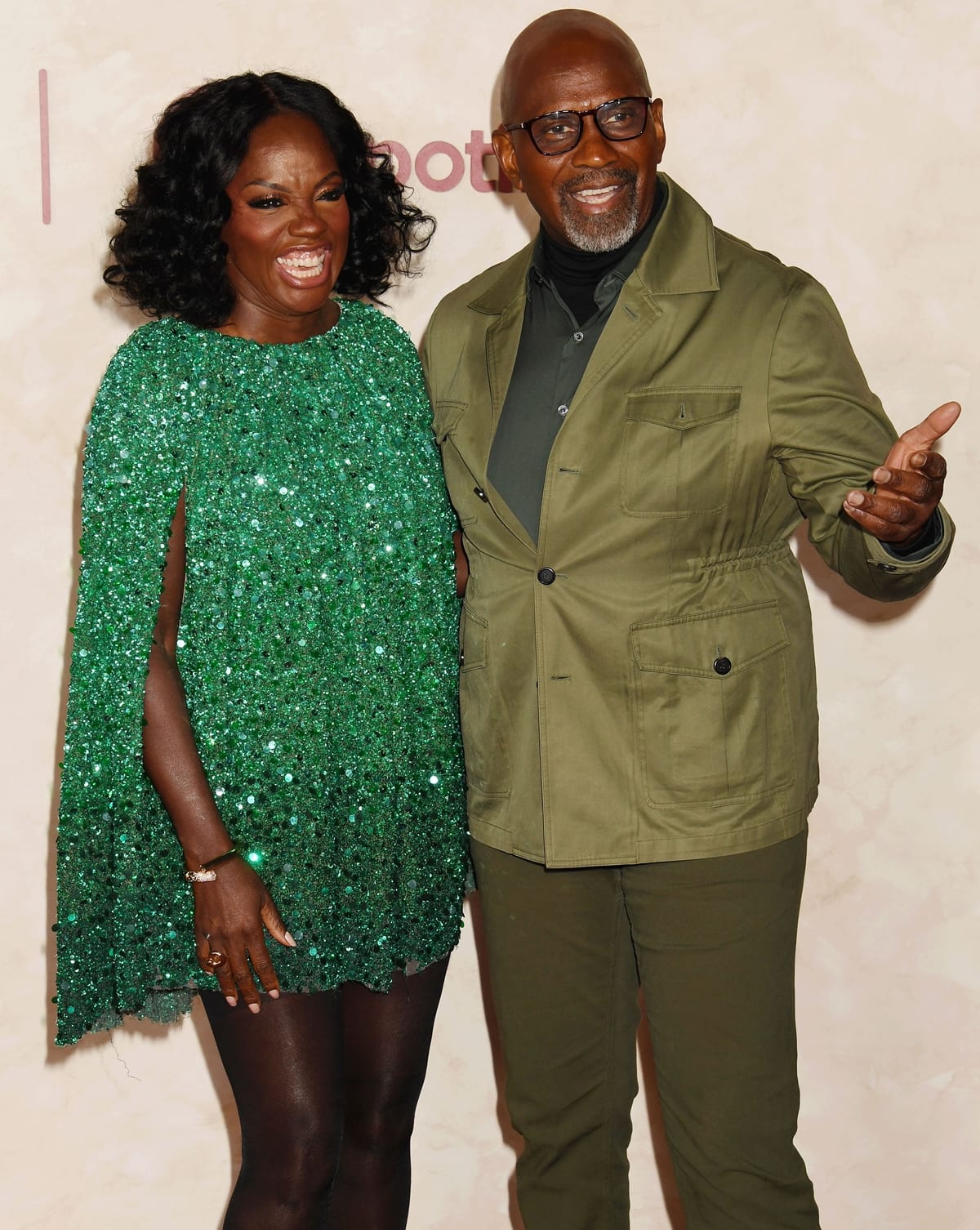 Viola Davis sparkled in a green sequined cape mini dress paired with sheer black tights, while Julius Tennon opted for an olive green utility-style suit layered over a dark turtleneck at the Los Angeles premiere of The Hunger Games: The Ballad of Songbirds Snakes on November 13, 2023, at TCL Chinese Theatre