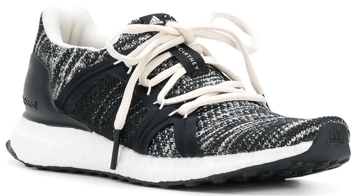 The Adidas by Stella McCartney Ultraboost Parley sneakers combine a black-and-grey knit upper with Boost cushioning, blending performance comfort with eco-conscious design made from recycled ocean plastic