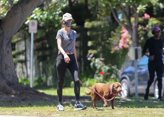 Alessandra Ambrosio steps out for a masked jog with her dog in Santa Monica on May 19, 2020, embracing a low-key athleisure look during her off-duty workout