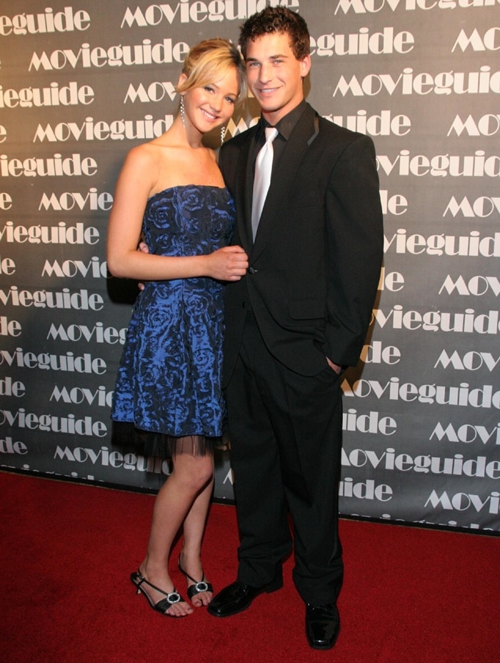 Jennifer Lawrence stuns in a strapless blue floral dress paired with black and silver open-toe heels while attending the Movieguide Awards with Clay Adler in 2007