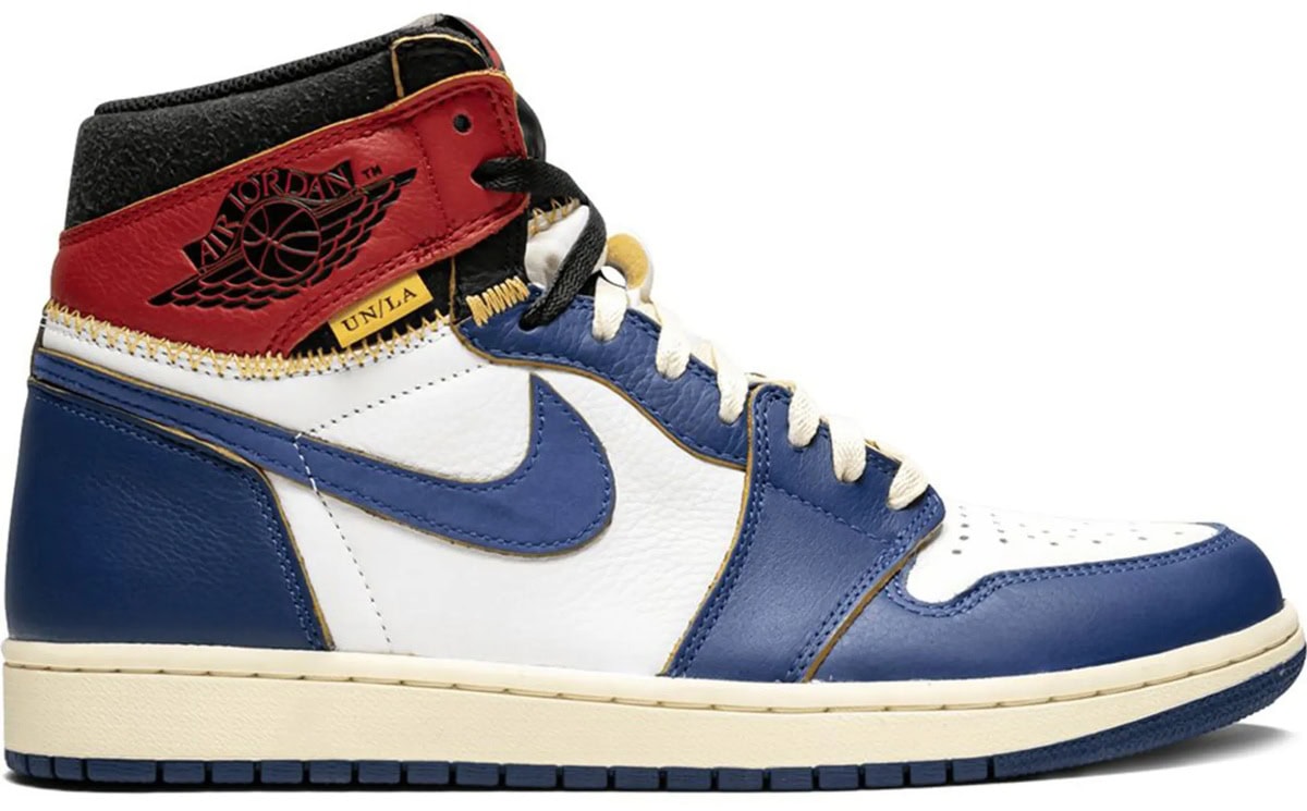 The Union Los Angeles x Air Jordan 1 Retro High OG NRG “Storm Blue” fused two original 1985 Jordan colorways into one reconstructed silhouette, with exposed yellow zig-zag stitching, vintage-inspired midsoles, and premium tumbled leather helping transform the sneaker into a modern streetwear grail