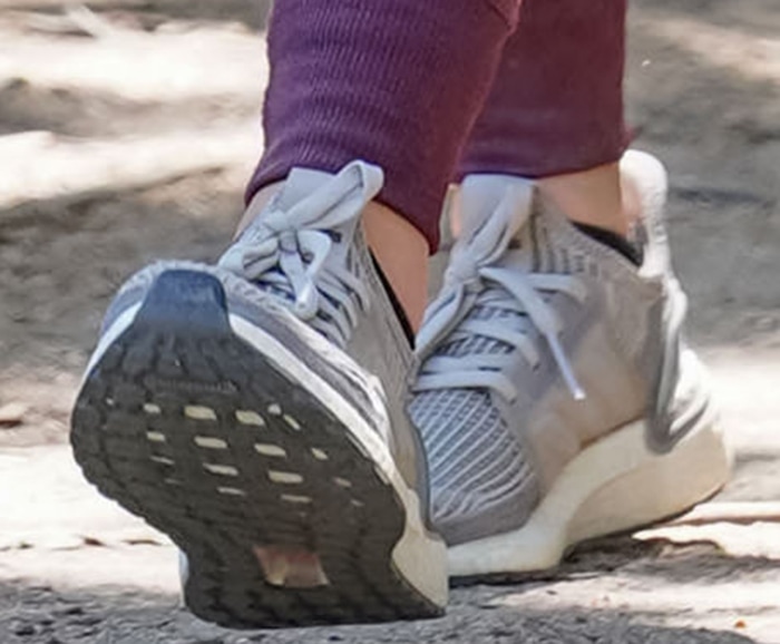 Lucy Hale finishes her sporty Studio City look with gray Adidas Ultraboost running sneakers featuring the signature Boost midsole and Primeknit upper