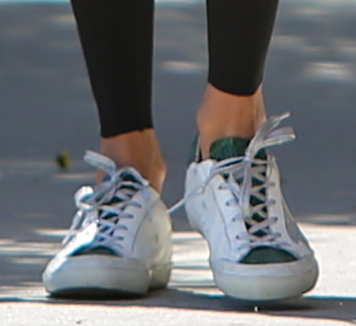 Close-up of Alessandra Ambrosio's off-white Golden Goose Superstar crystal crocodile sneakers