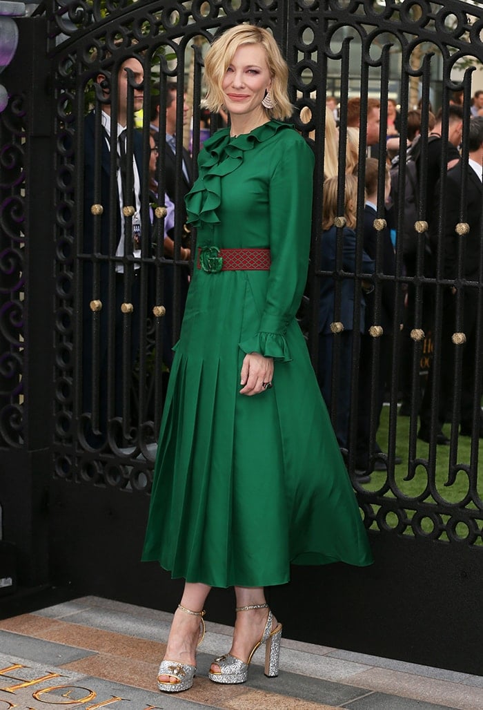 Cate Blanchett embraces Gucci's romantic Victoriana aesthetic in an emerald-green Resort 2019 dress, cinched with a signature logo belt and paired with glittering bee-accented platform sandals