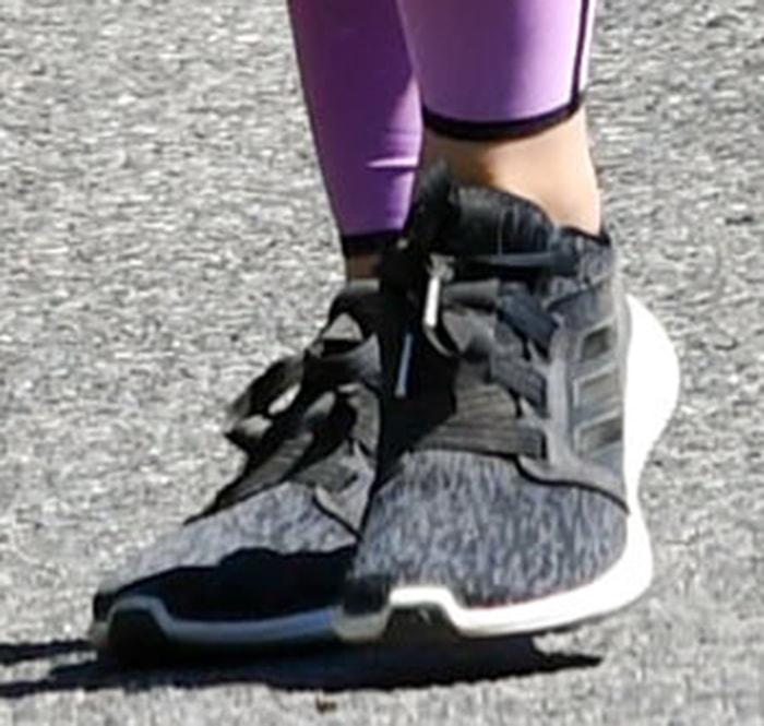 Lucy Hale finishes her sporty athleisure look with lightweight Adidas Edge Lux 3 sneakers, pairing the flexible running shoes with purple workout leggings