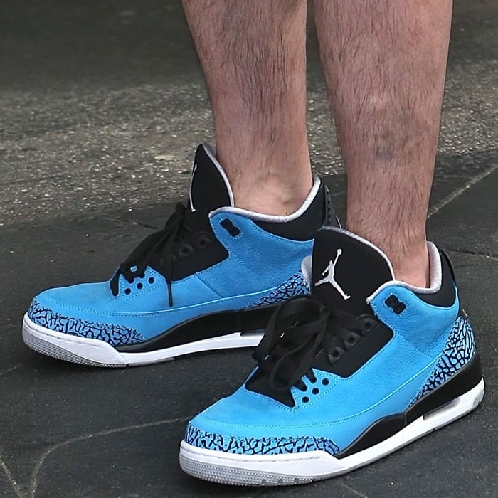 Mark Wahlberg's feet in Air Jordan sneakers with Michael Jordan's name and world-renowned “Jumpman” silhouette