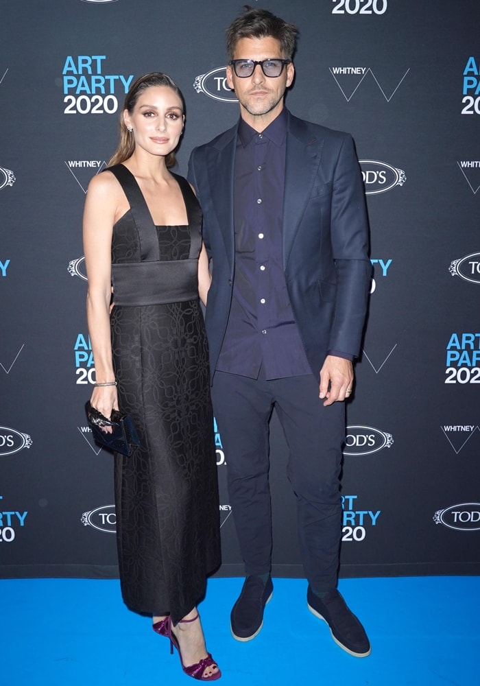 Olivia Palermo styled a sleek Hermès dress with burgundy strappy heels, while Johannes Huebl complemented her polished look in a tailored navy suit and minimalist slip-on shoes at the 2020 Whitney Art Party in New York City