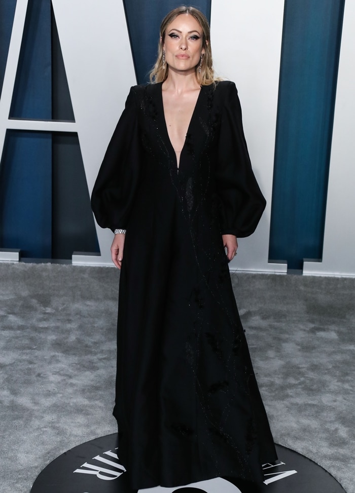 Olivia Wilde brings understated glamour to the 2020 Vanity Fair Oscar Party, pairing a plunging black Fendi couture jumpsuit with sleek black Stuart Weitzman platform sandals