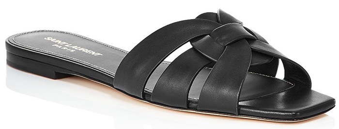 Saint Laurent's "Nu Pieds" slide sandals combine interwoven leather straps, a modern square toe, and a sleek flat sole, making them a versatile luxury staple for understated summer style