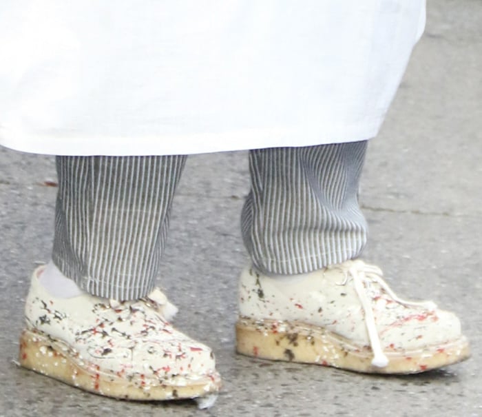 Whoopi Goldberg steps out in her signature quirky style, wearing chunky paint-splattered platform shoes in size 11—unexpected for her petite 5'5" frame